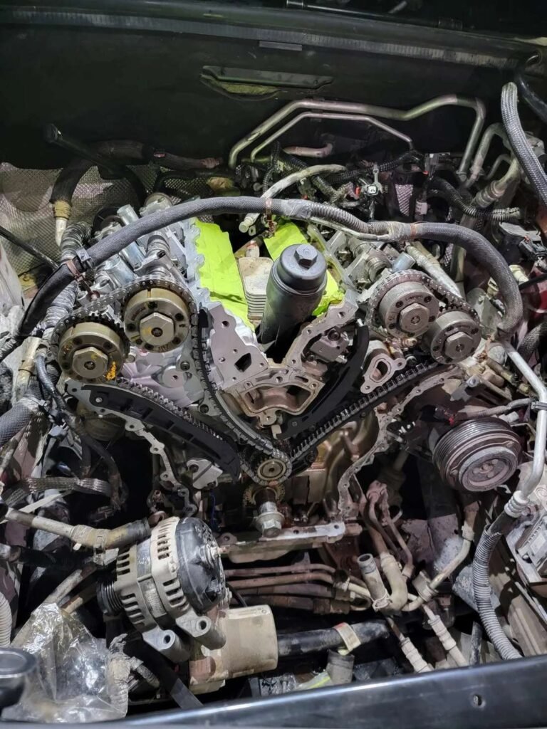 A V-configuration engine opened up mid-rebuild at Roy&rsquo;s, both banks of timing chains and camshaft phasers exposed